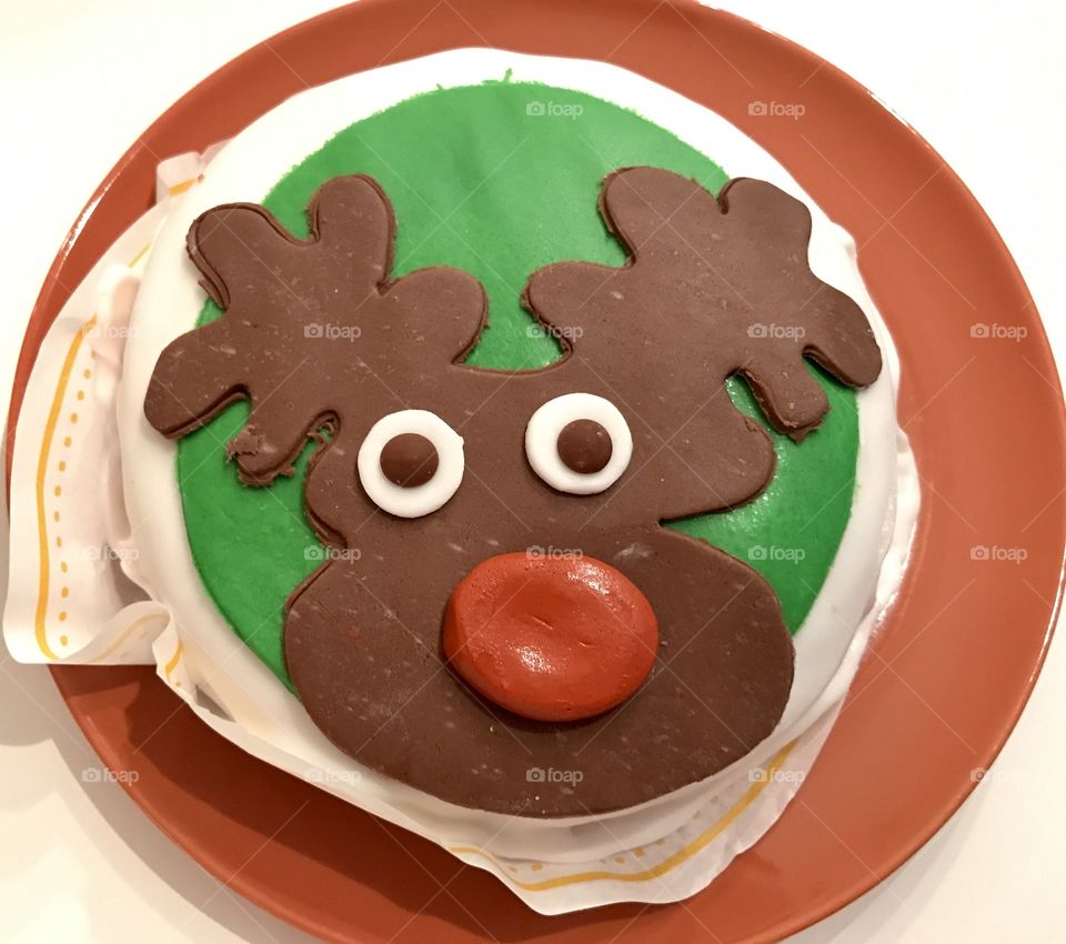Funny Christmas cake with a chocolate deer face