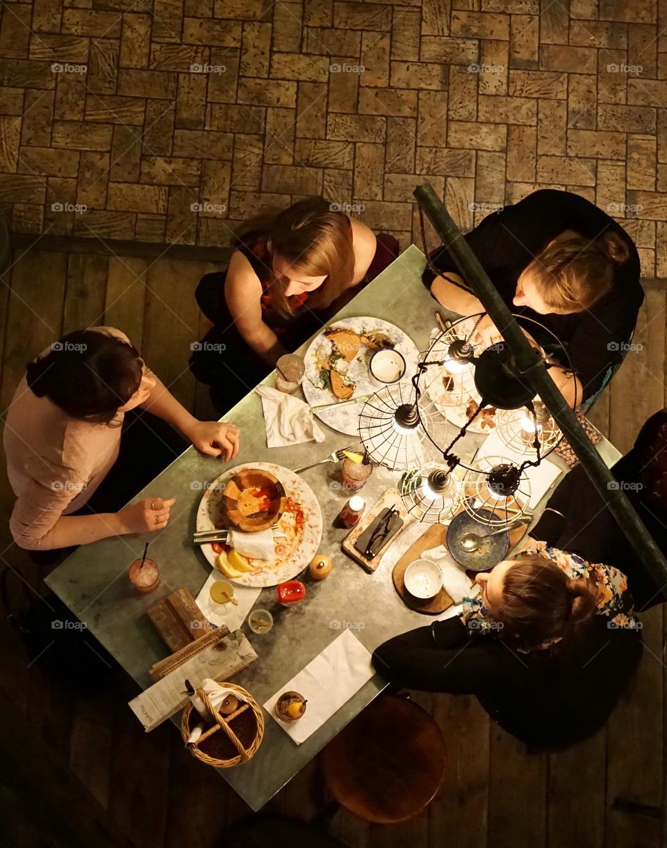 Friends chatting after a meal out …. I love the light shining down on this group of people 💜