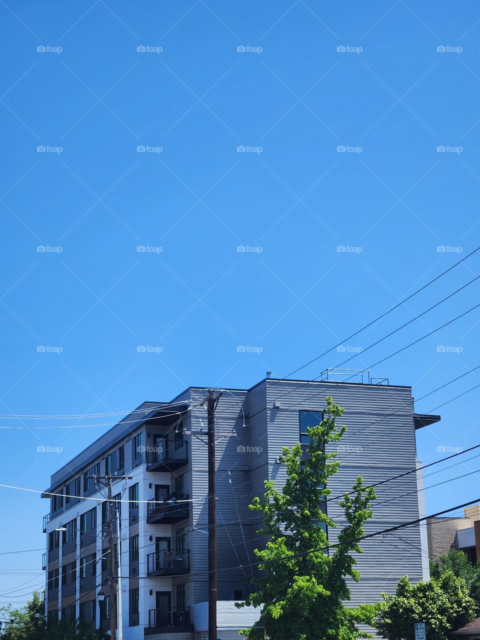 gray apartment building against blue sky in Oregon Suburbs