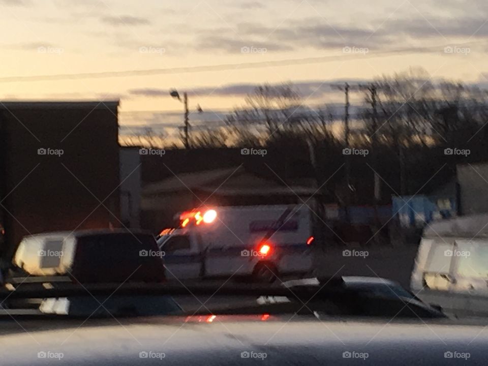 Ambulance going on a call.red lights flashing and the horn honking move out of the way!