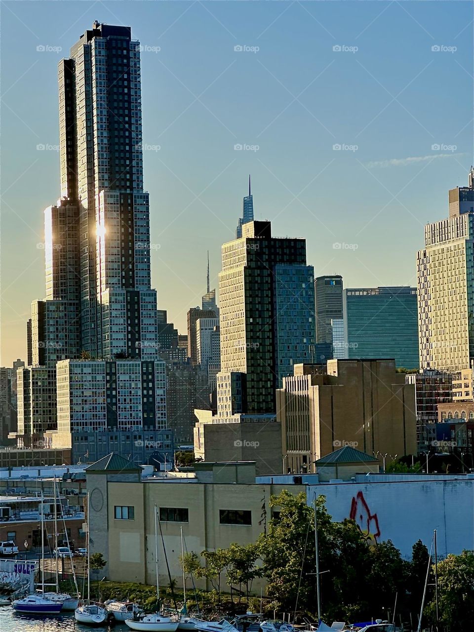 These are parts of LIC in closeup with “Manhattan” behind it at “Newtown Creek” seen from the “Pulaski Bridge” that connects “Greenpoint”, Brooklyn to LIC, Queens. 2024. Hypnotic Productions