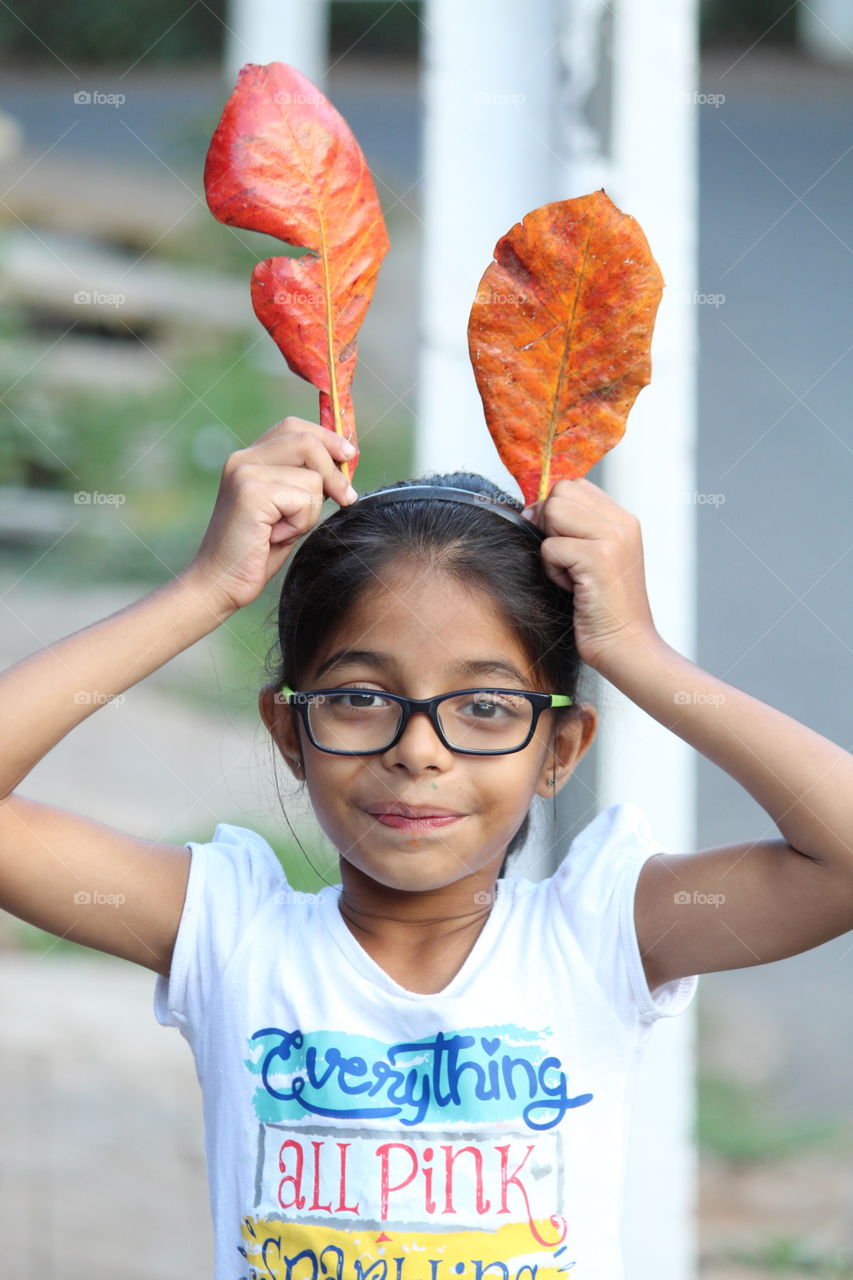 Girl holding leaf in hand