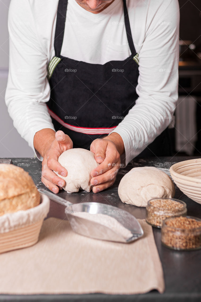 Folding and kneading sourdough for tasty and healthy loaf of bread.