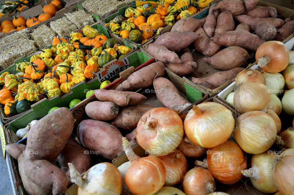 Onions, sweet potatoes and squash at farmers market. 
