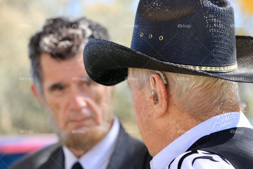 Elderly cowboy having a conversation with President Abraham Lincoln (actor reenactment) 