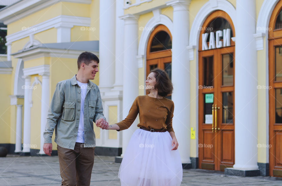 Love story of stylish funny couple. People walking, dancing and kissing in the autumn city. Wedding celebration and date concept.