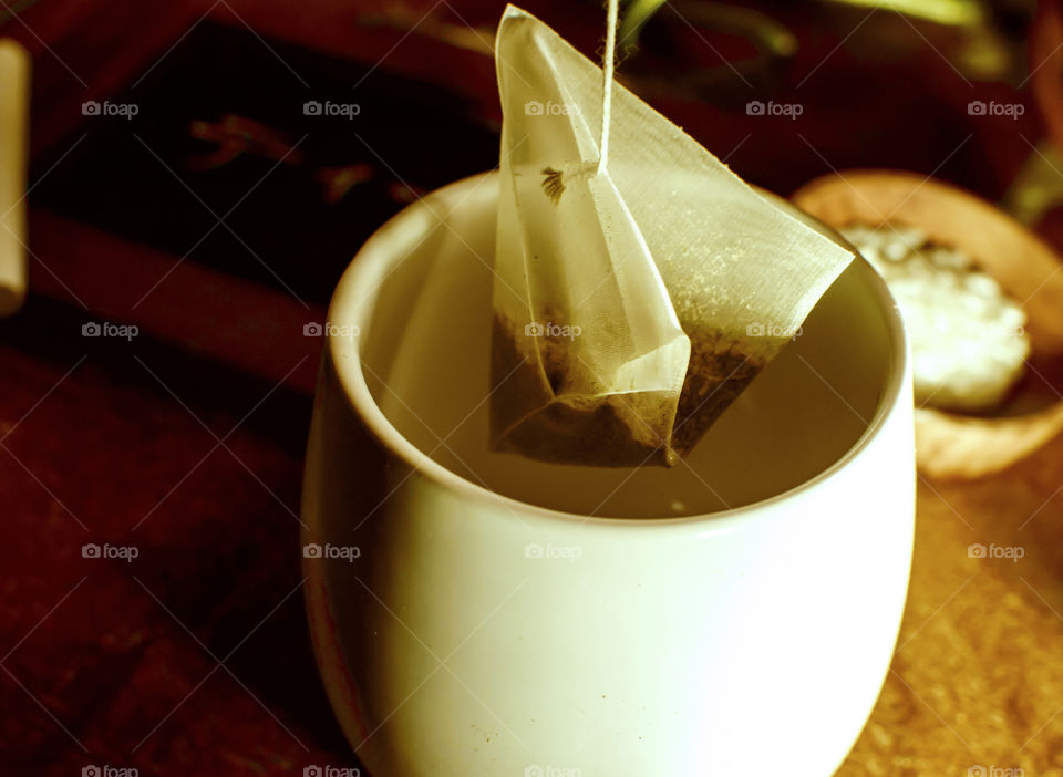 Japanese green tea with toasted rice in triangle tea bag with rice in small bowl conceptual zen tranquility background 