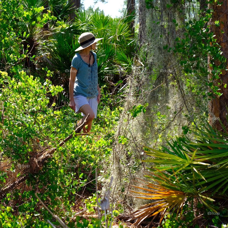 Woman hiking through the forest.