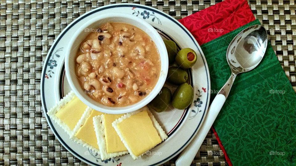 Bowl of black eyed pea and olive in plate