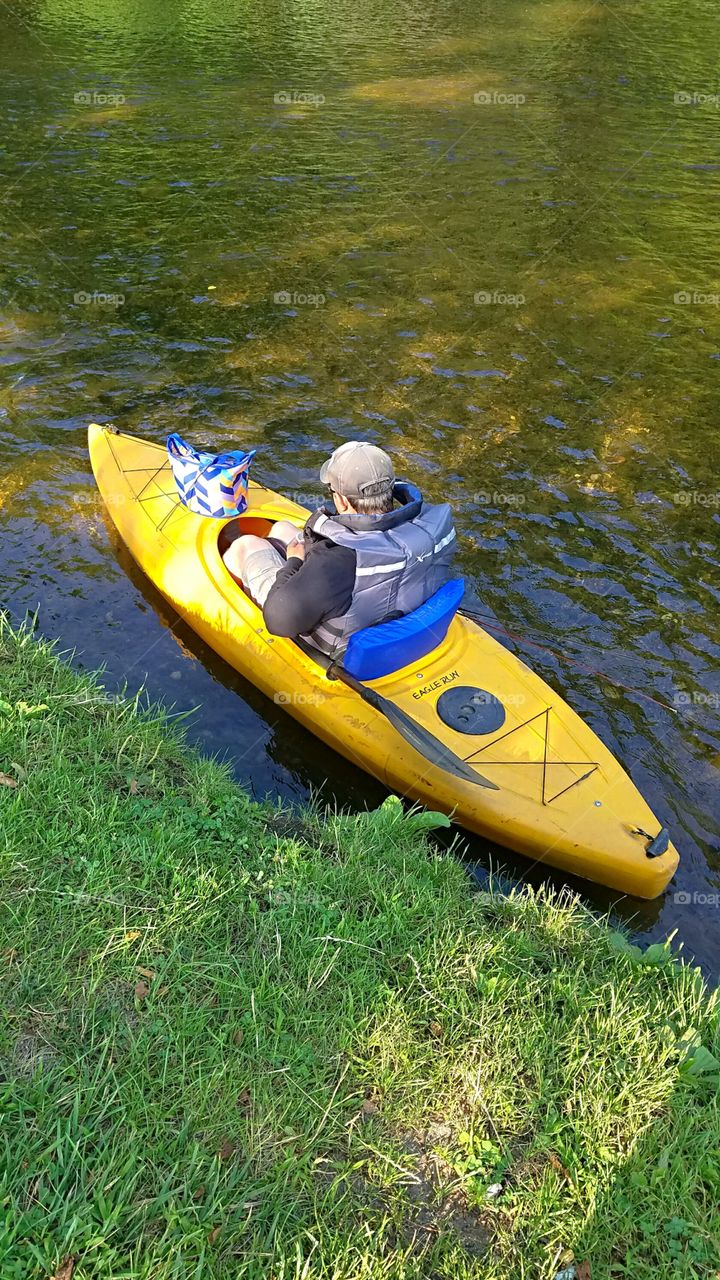 starting down the river in a kayak