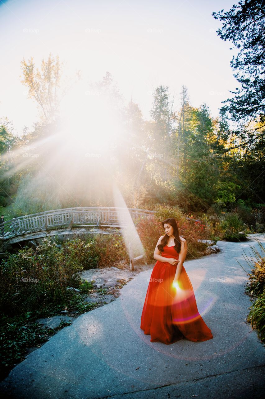 Young woman under amazing sun flares