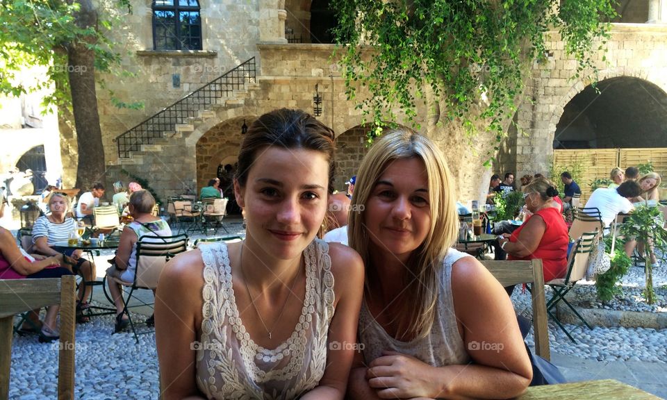 Portrait of female friends sitting in restaurant