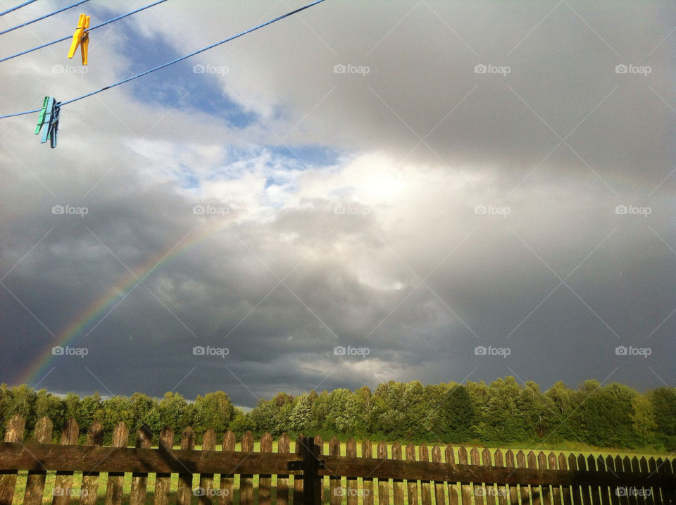 field rainbow dark clouds washing line by Nikita80