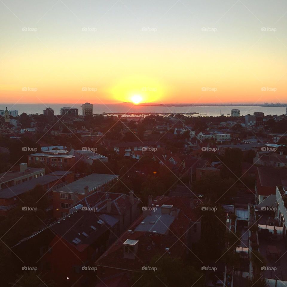 Sunset photo overlooking St Kilda in Melbourne from a rooftop during a bbq. A vibrant, exciting and funky town. 