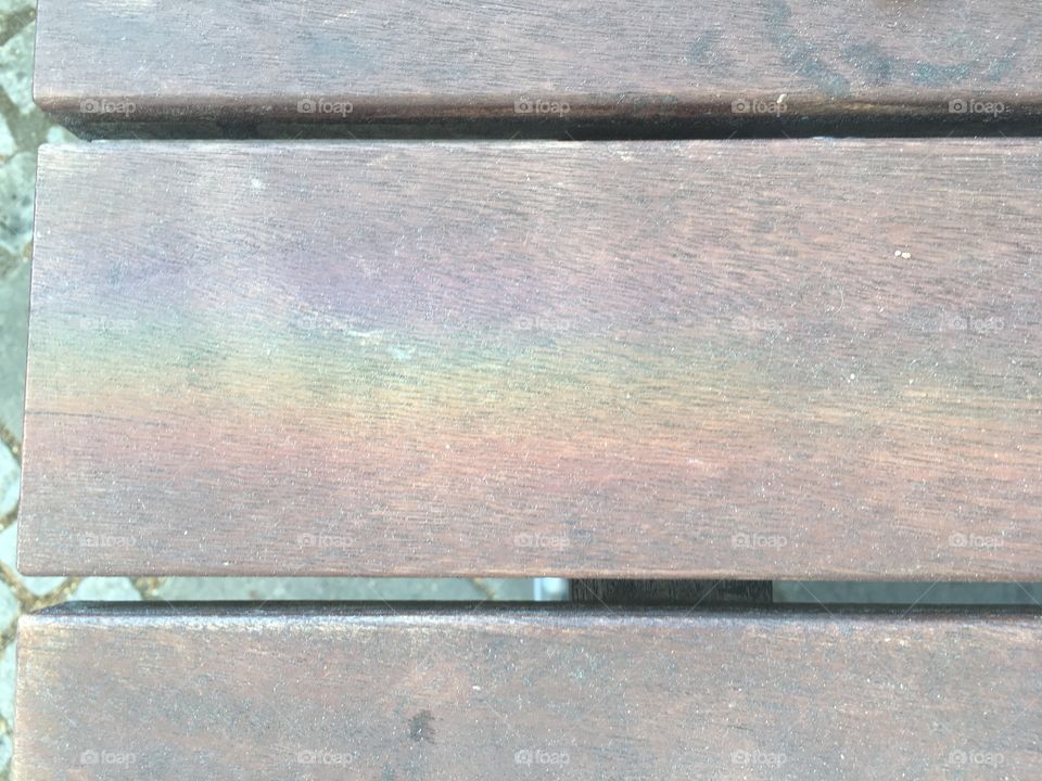 Prism rainbow caught on table.
