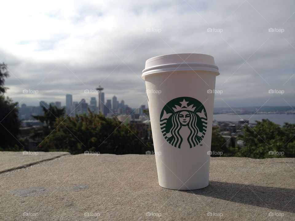 Starbucks cup at Kerry Park with a shot of downtown Seattle