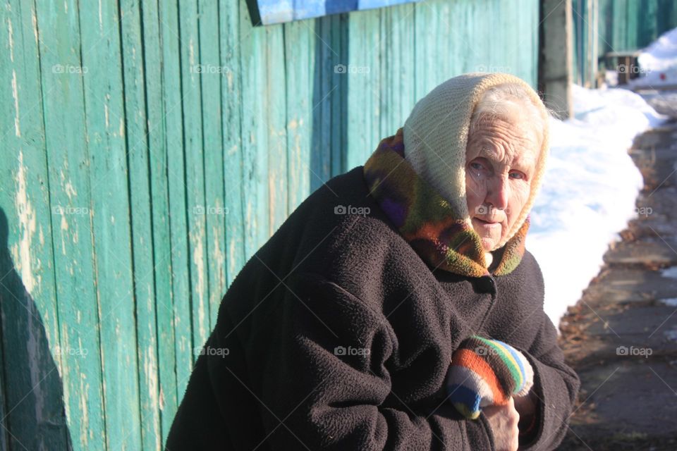 Senior woman in warm clothes looking at camera