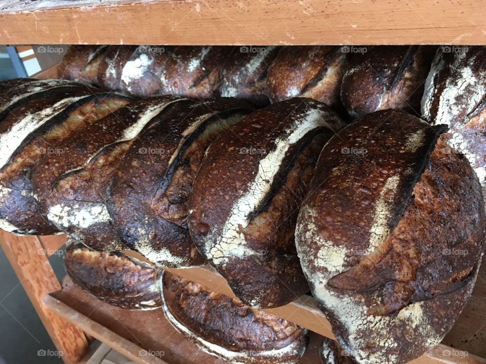 Freshly baked bread on a wooden rack