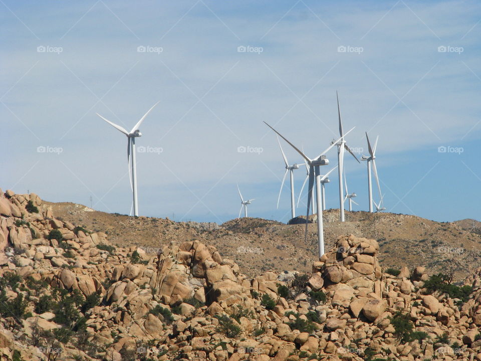 Windmill generating electricity at windfarm