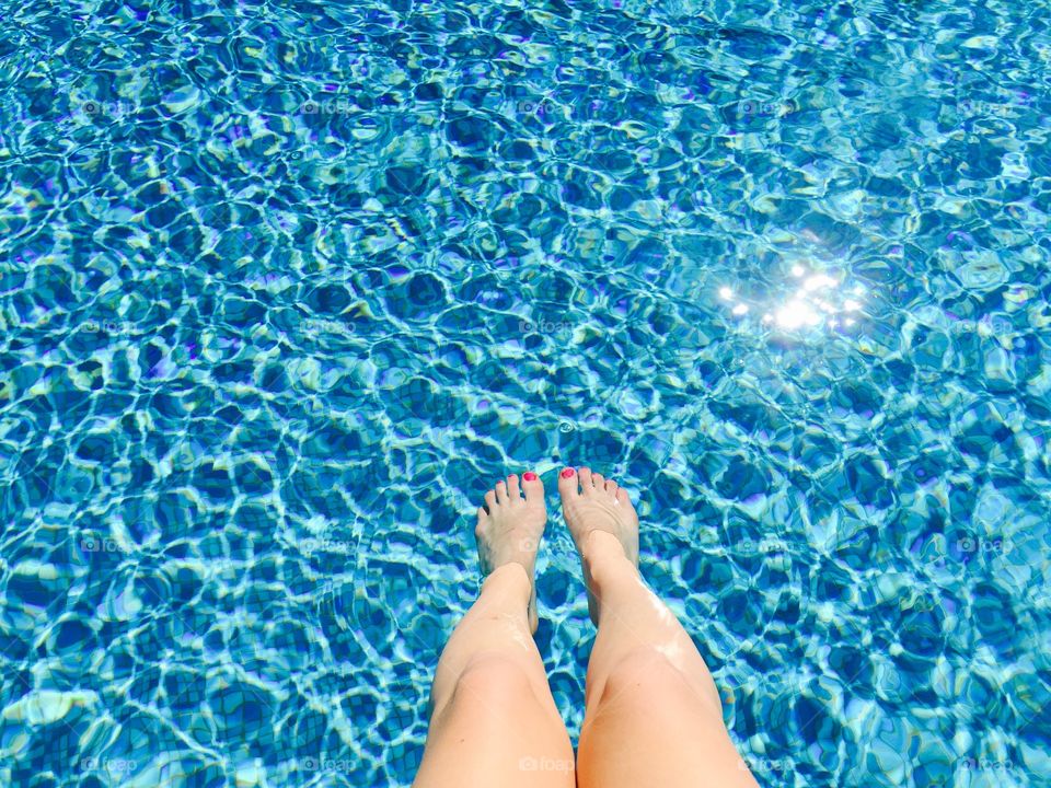Woman's legs in the pool
