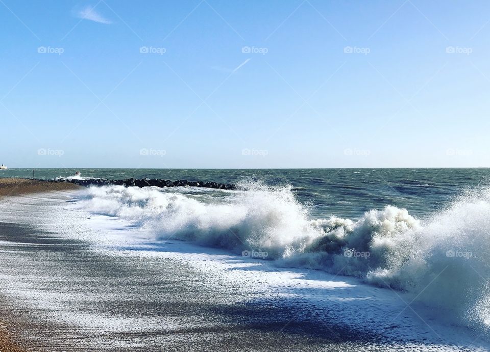 Crashing waves of Folkestone seafront UK on a crisp, sunny day