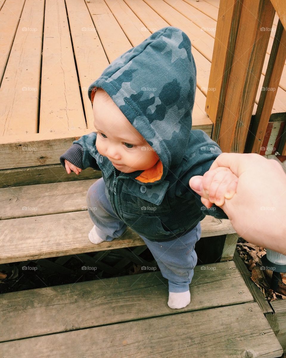 Child taking first steps down stairs