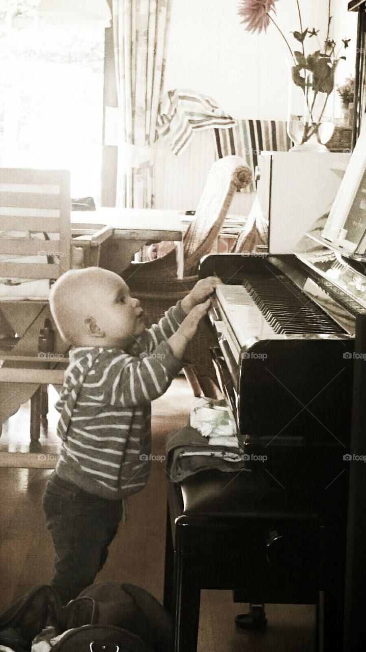 baby plays piano music sepia child