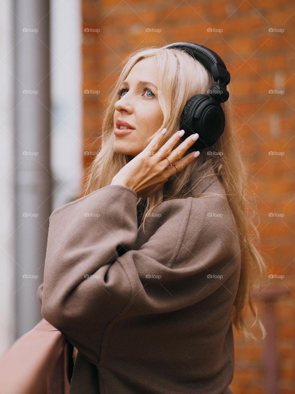 Young beautiful blonde woman in headphones, listen music, portrait of woman 