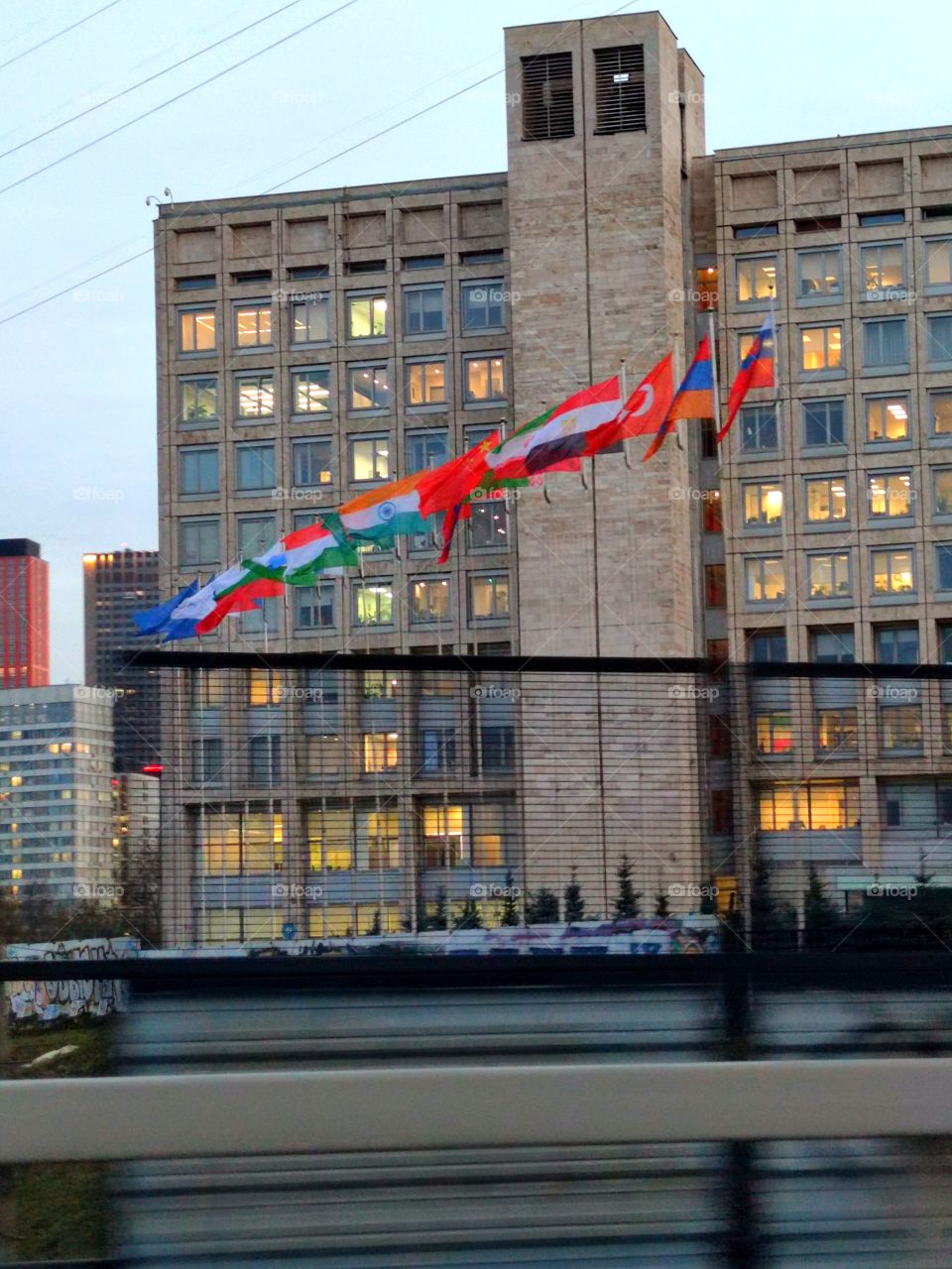 Moscow.  The Rosatom building.  In front of the building, multicolored flags of different countries