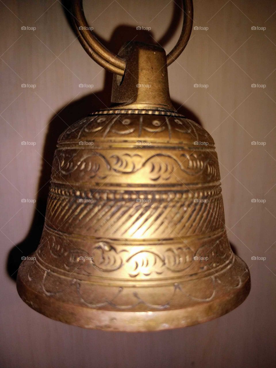 a brass bell on the wall