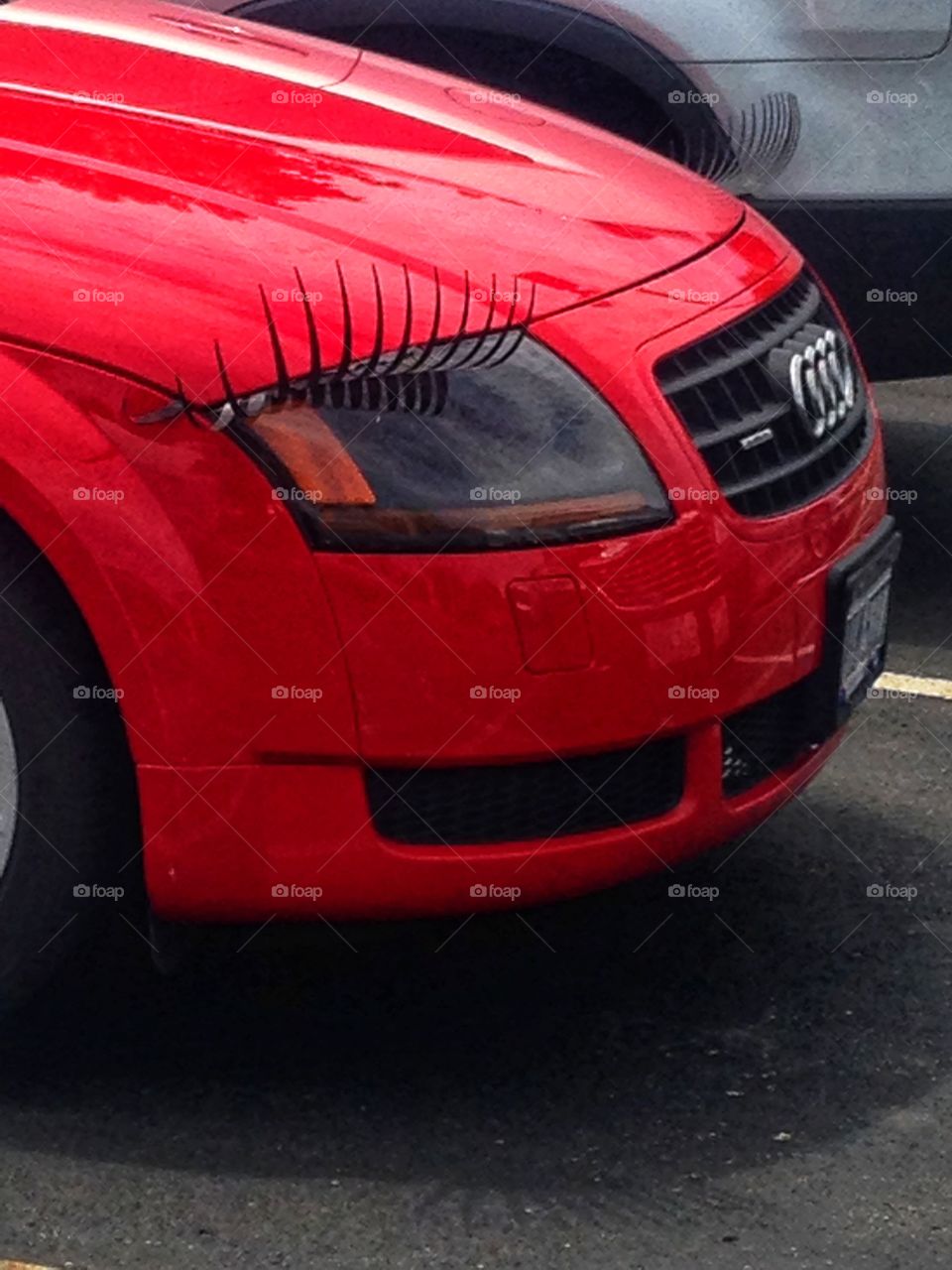 Red Audi with eyelash