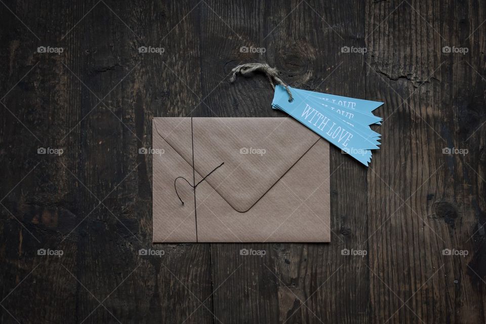 brown envelope on wooden background with love tag