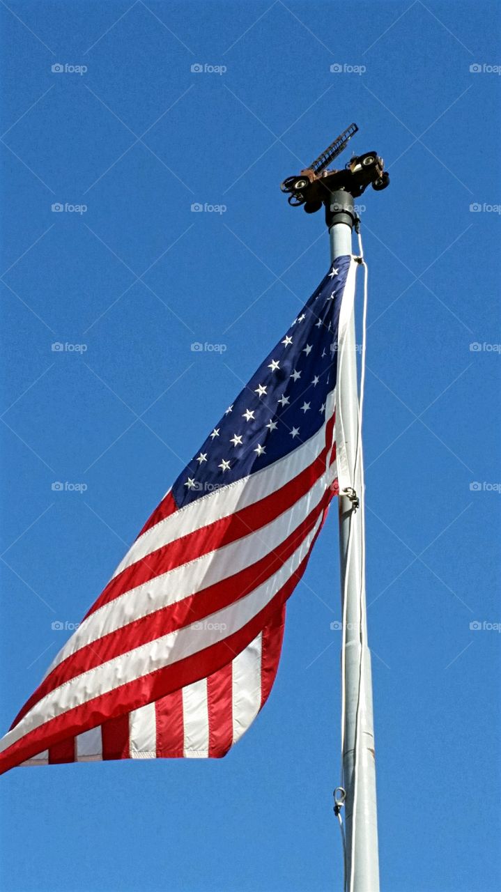 Flag waving at local Fire Station with a model Hook and Ladder Truck atop the flag pole!