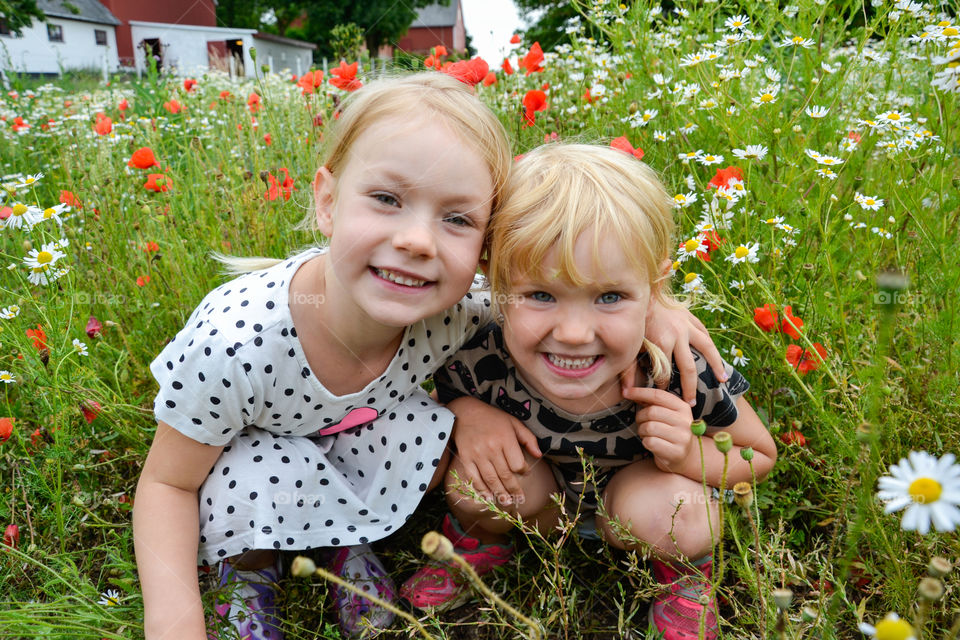 Two sisters is playing in a field outside Malmö Sweden.