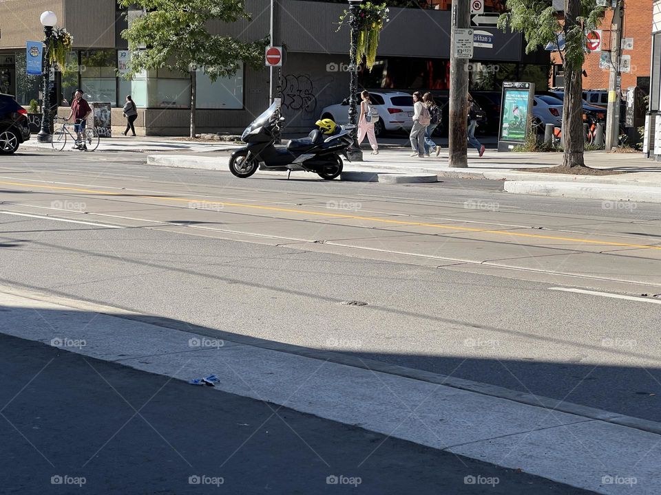 A parked scooter on a sunny afternoon.