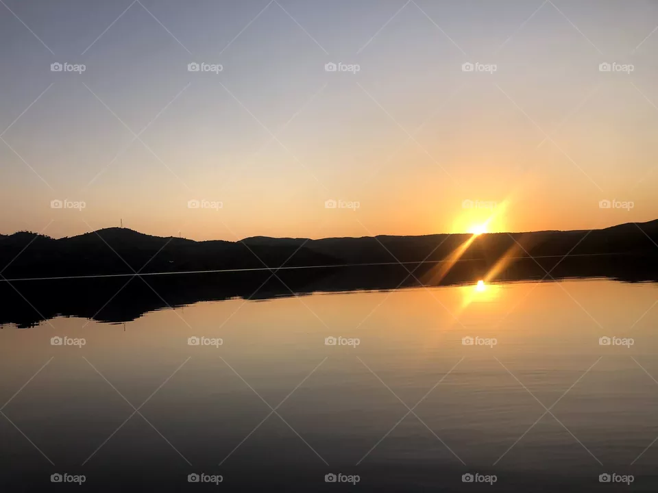 Sunset with the sun reflecting on the river