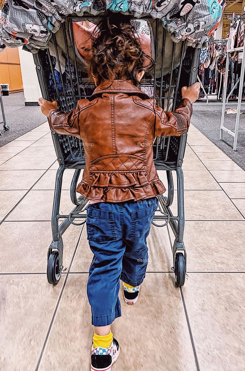 Toddler pushes cart in the store, toddler helps mommy shop, little kid with a big cart, shopping with mommy in the store, children in stores