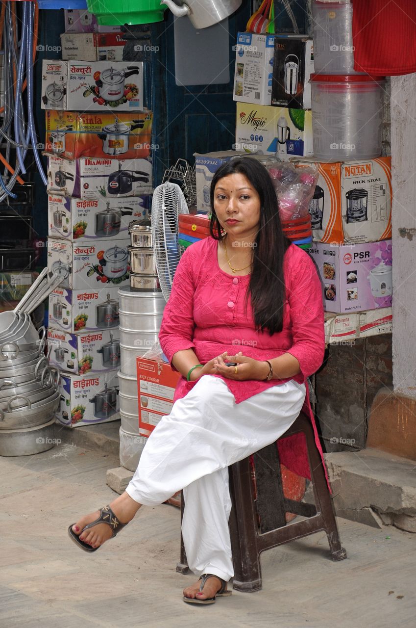 woman sitting at the market stall on the street of kathmandu, nepal