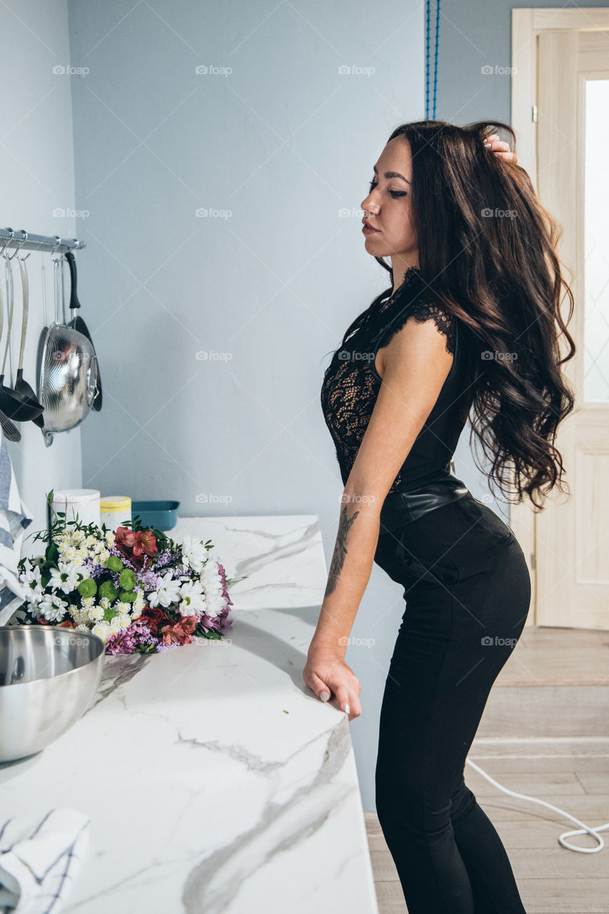 Beautiful dark hair girl in kitchen interior