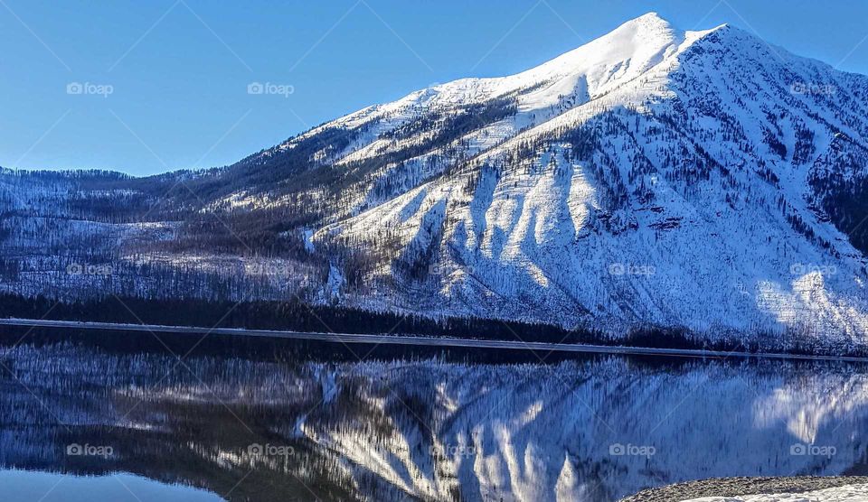 snowy mountain reflection on lake