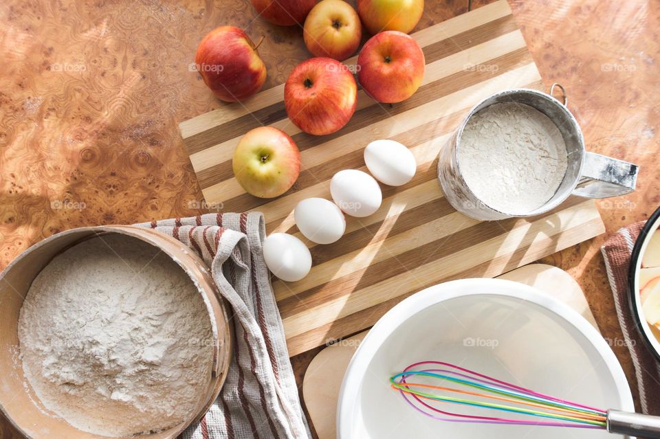 Making homemade puffed apple pie with eggs, sugar and flour.