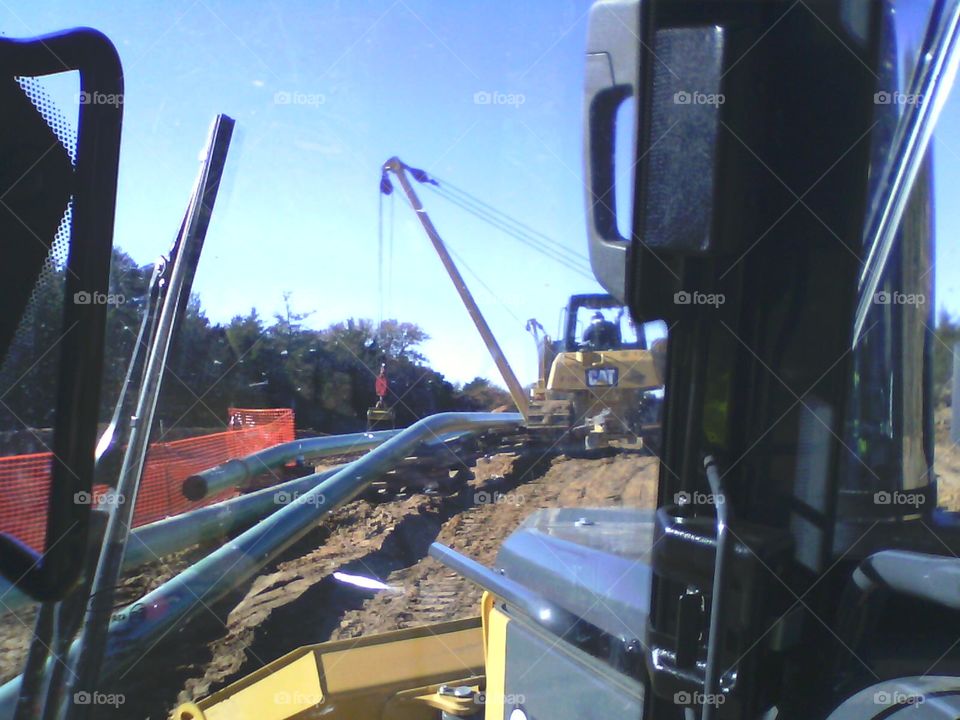 Working backfill on the oil pipeline. 