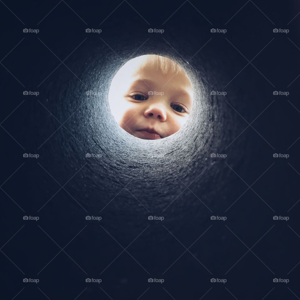 Boy looking inside the tunnel