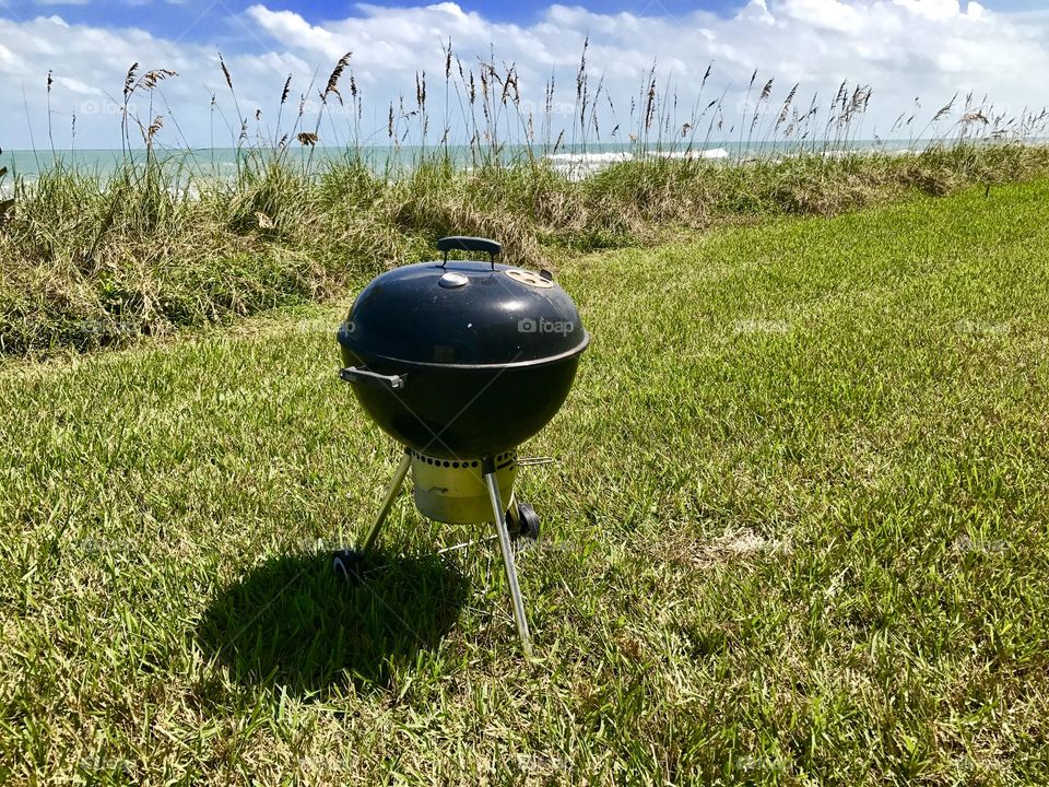 Barbecue grill in backyard in front of ocean, Satellite Beach, Florida, USA 