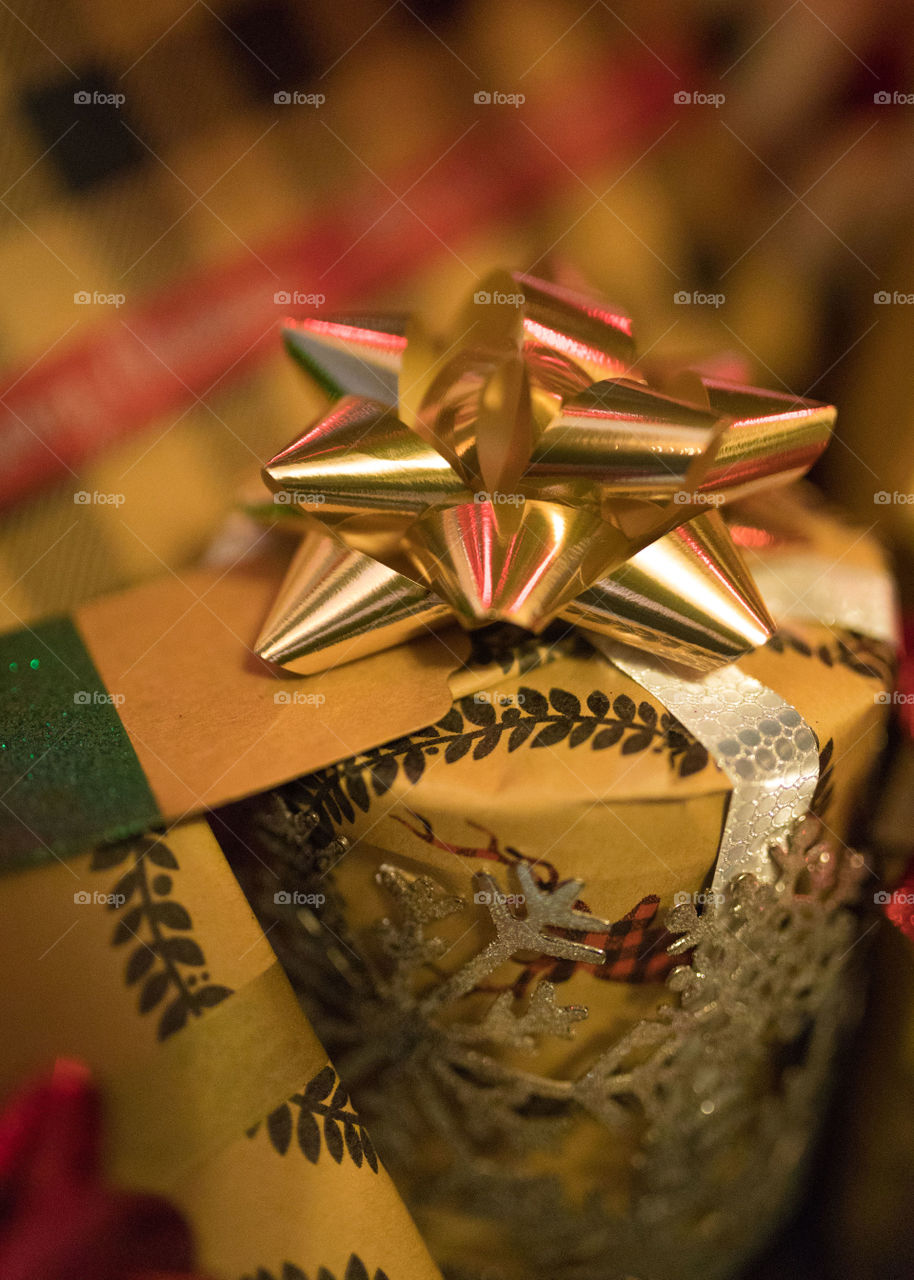 Rustically wrapped Christmas gifts hiding under the tree. 