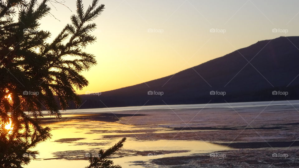 sunset on a reservoir and mountains in the Urals in Russia