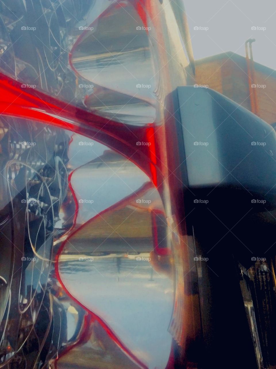 To show more than „meets the eye“ is my specialty. This surreal picture is composed of parts of a parked red sportscar that I photographed from an unusual angle in LIC, Queens, NY in 2020 Hypnotic Productions