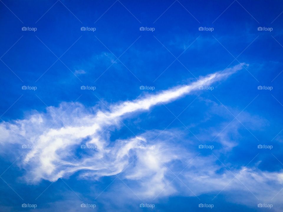White puffy clouds and blue sky background