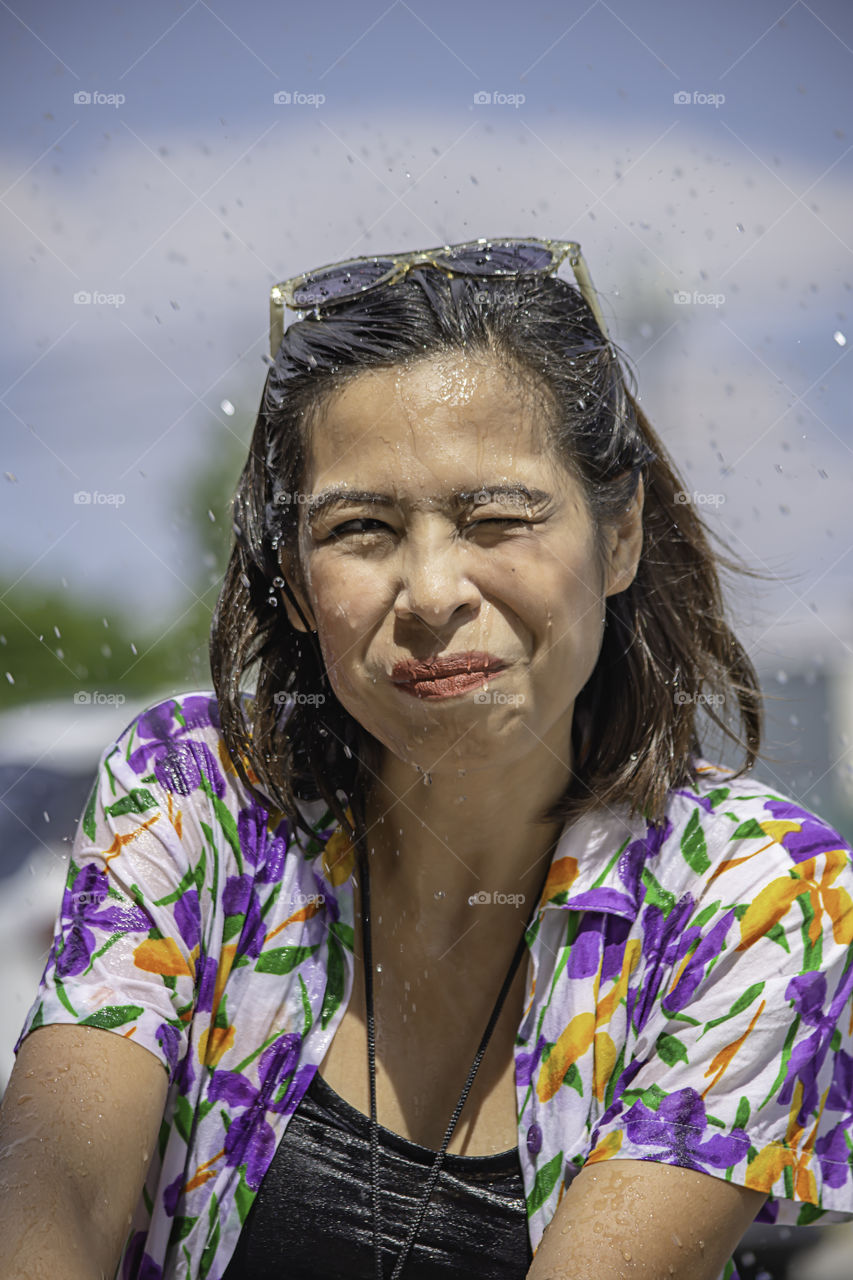 Asian woman play water in Songkran festival or Thai new year in Thailand.