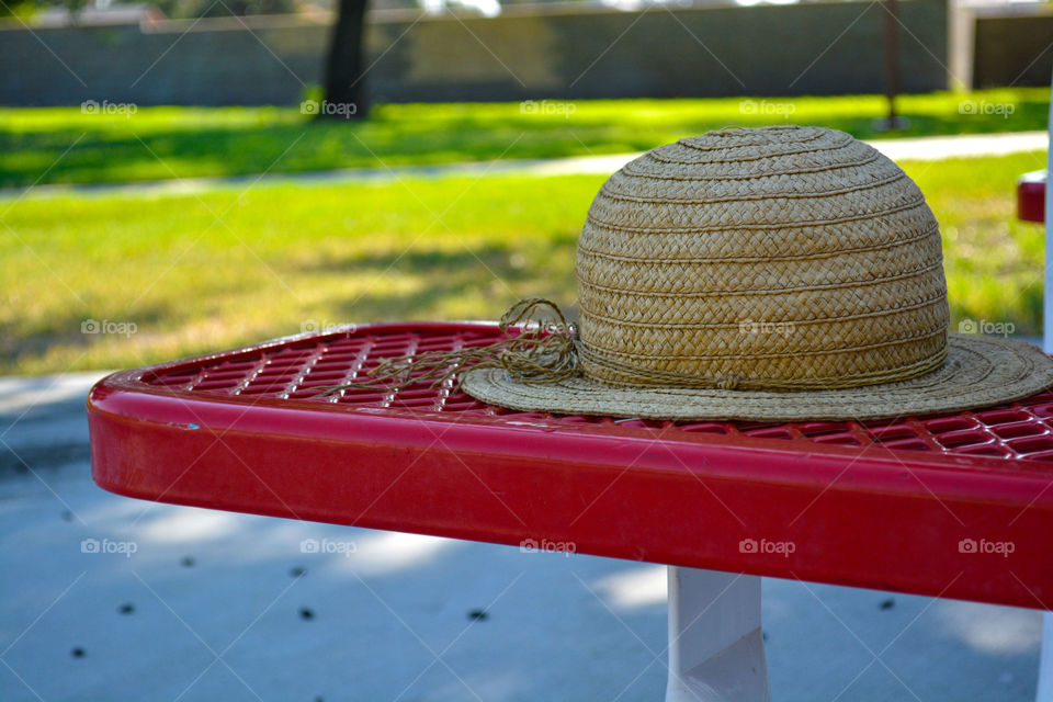 Hat on red park bench.
